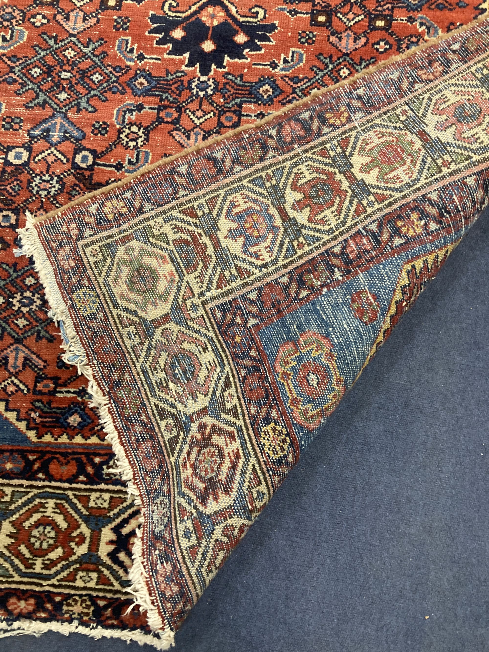 A Caucasian Hamadan red ground rug, 220 x 136cm